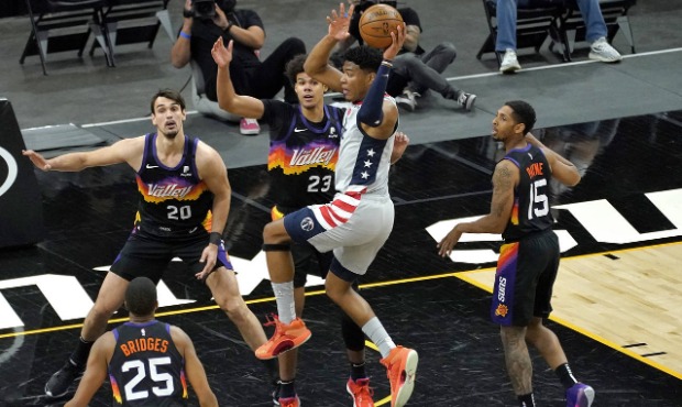 Washington Wizards forward Rui Hachimura looks to pass as Phoenix Suns forward Cameron Johnson (23)...