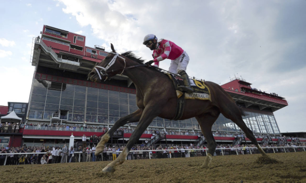 Flavien Prat atop Rombauer crosses the finish line to win the Preakness Stakes horse race at Pimlic...