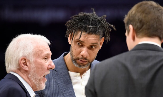 Head coach Gregg Popovich talks to assistant coach Tim Duncan of the San Antonio Spurs during the s...