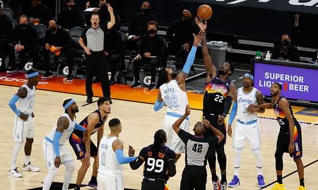 Deandre Ayton #22 of the Phoenix Suns and Markieff Morris #88 of the Los Angeles Lakers jump for th...