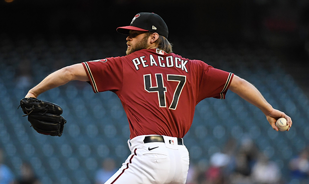 Matt Peacock #47 of the Arizona Diamondbacks delivers a first inning pitch against the Miami Marlin...
