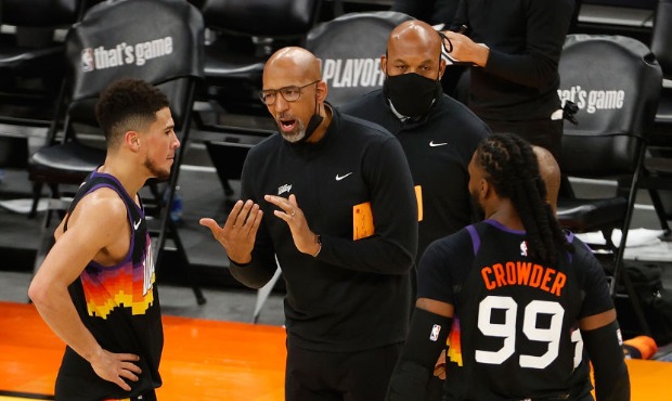 Head coach Monty Williams of the Phoenix Suns talks with Devin Booker #1 and Jae Crowder #99 during...