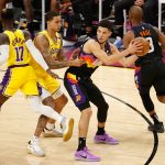 PHOENIX, ARIZONA - MAY 25: Devin Booker #1 of the Phoenix Suns looks to pass against Kyle Kuzma #0 of the Los Angeles Lakers during the first half of Game Two of the Western Conference first-round playoff series at Phoenix Suns Arena on May 25, 2021 in Phoenix, Arizona. (Photo by Christian Petersen/Getty Images)