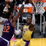 LOS ANGELES, CALIFORNIA - MAY 27:  Dennis Schroder #17 of the Los Angeles Lakers makes a layup past the defense of Deandre Ayton #22 of the Phoenix Suns during the first half of Game Three of the Western Conference first-round playoff series at Staples Center on May 27, 2021 in Los Angeles, California. (Photo by Sean M. Haffey/Getty Images)