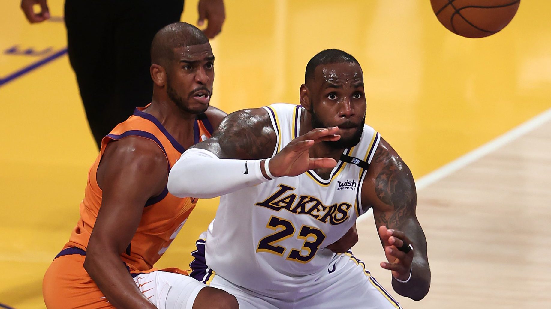 Chris Paul #3 of the Phoenix Suns defends against a pass to LeBron James #23 of the Los Angeles Lak...