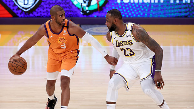 LeBron James #23 of the Los Angeles Lakers defends against Chris Paul #3 of the Phoenix Suns during...