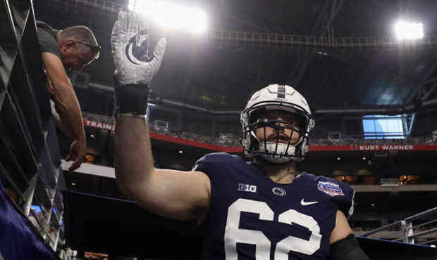 Offensive lineman Michal Menet #62 of the Penn State Nittany Lions walks out to the field for the s...