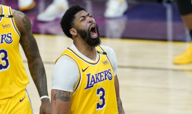 Los Angeles Lakers forward Anthony Davis shouts as he celebrates a stop against the Phoenix Suns du...