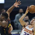 Phoenix Suns' Dario Saric, right, grabs a rebound against the Cleveland Cavaliers in the first half of an NBA basketball game, Tuesday, May 4, 2021, in Cleveland. (AP Photo/Tony Dejak)
