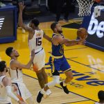 Golden State Warriors guard Stephen Curry, right, shoots against Phoenix Suns forward Frank Kaminsky, from left, guard Devin Booker and guard Cameron Payne (15) during the first half of an NBA basketball game in San Francisco, Tuesday, May 11, 2021. (AP Photo/Jeff Chiu)