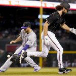 
              Arizona Diamondbacks' Zac Gallen, right, runs out a bunt as Colorado Rockies' C.J. Cron fields the ball for the out during the third inning of a baseball game, Saturday, May 1, 2021, in Phoenix. (AP Photo/Matt York)
            