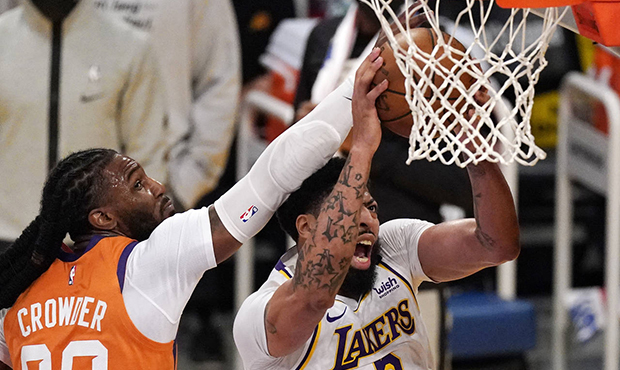 Los Angeles Lakers forward Anthony Davis, right, shoots as Phoenix Suns forward Jae Crowder defends...