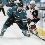 San Jose Sharks left wing Alexander Barabanov (94) and Arizona Coyotes right wing Clayton Keller (9) compete for possession of the puck during the first period of an NHL hockey game in San Jose, Calif., Saturday, May 8, 2021. (AP Photo/John Hefti)