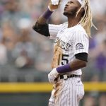 Colorado Rockies' Raimel Tapia gestures after driving in a run with a single and taking second base on the throw in the third inning of a baseball game against the Arizona Diamondbacks, Saturday, May 22, 2021, in Denver. (AP Photo/David Zalubowski)