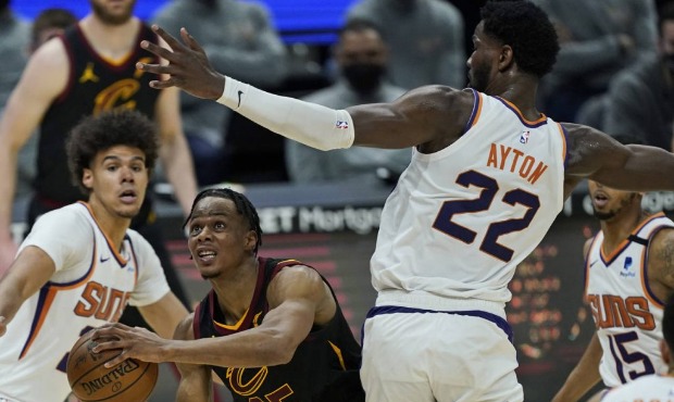 Cleveland Cavaliers' Isaac Okoro (35) drives to the basket against Phoenix Suns' Deandre Ayton (22)...