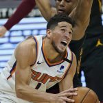 Phoenix Suns' Devin Booker (1) drives against Cleveland Cavaliers' Isaac Okoro (35) in the first half of an NBA basketball game, Tuesday, May 4, 2021, in Cleveland. (AP Photo/Tony Dejak)