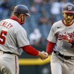 Washington Nationals' Trea Turner, right, is congratulated by third base coach Bob Henley after hitting a home run against the Arizona Diamondbacks during the first inning of a baseball game Friday, May 14, 2021, in Phoenix. (AP Photo/Darryl Webb)