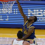 Golden State Warriors forward Andrew Wiggins, top, shoots over Phoenix Suns forward Frank Kaminsky (8) during the second half of an NBA basketball game in San Francisco, Tuesday, May 11, 2021. (AP Photo/Jeff Chiu)