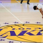 Los Angeles Lakers forward Anthony Davis rests at mid-court during a break in play in the second half of the team's NBA basketball game against the Phoenix Suns on Sunday, May 9, 2021, in Los Angeles. (AP Photo/Marcio Jose Sanchez)