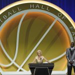 Michael Jordan, right, listens as former Baylor coach Kim Mulkey, now at LSU, speaks while being enshrined with the 2020 Basketball Hall of Fame class, Saturday, May 15, 2021, in Uncasville, Conn. (AP Photo/Kathy Willens)