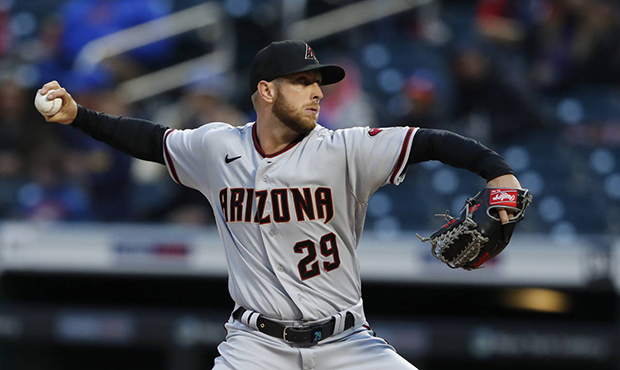 Arizona Diamondbacks starting pitcher Merril Kelly throws to a New York Mets batter during the firs...