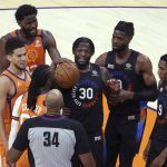 New York Knicks forward Julius Randle (30) stands near center Nerlens Noel (3) and guard RJ Barrett (9) and Phoenix Suns guard Devin Booker and center Deandre Ayton (22) after getting called for a technical foul by referee Kevin Cutler during the second half of an NBA basketball game Friday, May 7, 2021, in Phoenix. Phoenix won 128-105. (AP Photo/Rick Scuteri)