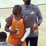 Phoenix Suns guard Chris Paul (3) is held back by coach Monty Williams after getting knocked to the floor by New York Knicks center Taj Gibson during the second half of an NBA basketball game Friday, May 7, 2021, in Phoenix. (AP Photo/Rick Scuteri)
