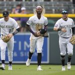 Colorado Rockies left fielder Raimel Tapia, center, is congratulated by shortstop Trevor Story, left, and center fielder Garrett Hampson after Tapia caught a shallow fly ball off the bat of Arizona Diamondbacks pinch-hitter Andrew Young to end the top of the seventh inning of a baseball game Saturday, May 22, 2021, in Denver. (AP Photo/David Zalubowski)