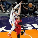 Phoenix Suns forward Jae Crowder (99) knocks the ball away from Portland Trail Blazers center Jusuf Nurkic (27) during the first half of an NBA basketball game, Thursday, May 13, 2021, in Phoenix. (AP Photo/Matt York)