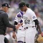 Colorado Rockies manager Bud Black, left, takes the ball from relief pitcher Yency Almonte as he is pulled from the game after walking Arizona Diamondbacks' David Peralta in the seventh inning of a baseball game Saturday, May 22, 2021, in Denver. (AP Photo/David Zalubowski)
