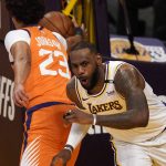 Los Angeles Lakers forward LeBron James, right, reacts after dunking as Phoenix Suns forward Cameron Johnson takes the ball during the first half in Game 4 of an NBA basketball first-round playoff series Sunday, May 30, 2021, in Los Angeles. (AP Photo/Mark J. Terrill)