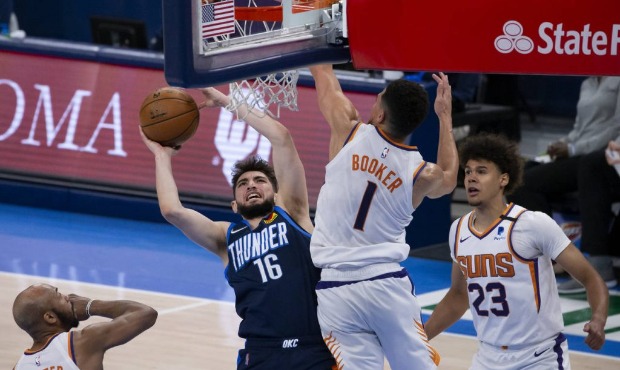 Oklahoma City Thunder guard Ty Jerome (16) shoots against Phoenix Suns guard Devin Booker (1) while...