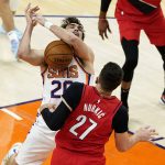 Phoenix Suns forward Dario Saric (20) has the ball knocked away by Portland Trail Blazers center Jusuf Nurkic (27) during the first half of an NBA basketball game, Thursday, May 13, 2021, in Phoenix. (AP Photo/Matt York)