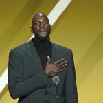 
              Kevin Garnett puts his hand on his heart during a speech during the 2020 Basketball Hall of Fame enshrinement ceremony, Saturday, May 15, 2021, in Uncasville, Conn. (AP Photo/Kathy Willens)
            