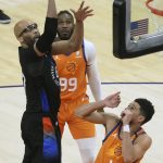 New York Knicks center Taj Gibson (67) shoots between Phoenix Suns forward Jae Crowder (99) and guard Devin Booker (1) during the second half of an NBA basketball game Friday, May 7, 2021, in Phoenix. (AP Photo/Rick Scuteri)