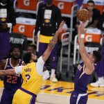 Phoenix Suns guard Devin Booker, right, shoots over Los Angeles Lakers forward Anthony Davis (3) during the first half in Game 3 of an NBA basketball first-round playoff series Thursday, May 27, 2021, in Los Angeles. (AP Photo/Marcio Jose Sanchez)