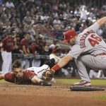Diamondbacks' Tim Locastro gets tagged out by St. Louis Cardinals first baseman Paul Goldschmidt (46) trying to score a run on a ball hit by Josh Rojas in the sixth inning during a baseball game, Sunday, May 30, 2021, in Phoenix. (AP Photo/Rick Scuteri)