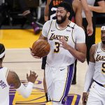 Los Angeles Lakers forward Anthony Davis (3) reacts after scoring next to teammates Kentavious Caldwell-Pope, left, Wesley Matthews (9) during the second half of an NBA basketball game against the Phoenix Suns on Sunday, May 9, 2021, in Los Angeles. (AP Photo/Marcio Jose Sanchez)