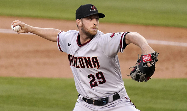 Arizona Diamondbacks starting pitcher Merrill Kelly throws to the plate during the first inning of ...