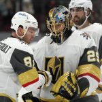 Vegas Golden Knights goaltender Marc-Andre Fleury (29) celebrates the team's win against the Arizona Coyotes with center Jonathan Marchessault, left, and right wing Alex Tuch (89) after an NHL hockey game Saturday, May 1, 2021, in Glendale, Ariz. Fleury has tied Roberto Luongo for third all-time with 489 career wins, as the Golden Knights won 3-2 in overtime. (AP Photo/Ross D. Franklin)