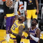 Los Angeles Lakers forward LeBron James (23) dunks past Phoenix Suns center Deandre Ayton during the second half in Game 3 of an NBA basketball first-round playoff series Thursday, May 27, 2021, in Los Angeles. (AP Photo/Marcio Jose Sanchez)
