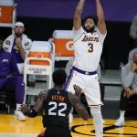 Los Angeles Lakers forward Anthony Davis (3) shoots over Phoenix Suns center Deandre Ayton (22) during the second half of an NBA basketball game Sunday, May 9, 2021, in Los Angeles. (AP Photo/Marcio Jose Sanchez)