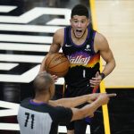 Phoenix Suns guard Devin Booker (1) argues with referee Rodney Mott (71) during the second half of Game 1 of an NBA basketball first-round playoff series against the Los Angeles Lakers, Sunday, May 23, 2021, in Phoenix. (AP Photo/Ross D. Franklin)