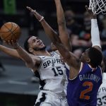 San Antonio Spurs guard Quinndary Weatherspoon (15) drives to the basket against Phoenix Suns guard Langston Galloway (2) during the second half of an NBA basketball game in San Antonio, Saturday, May 15, 2021. (AP Photo/Eric Gay)