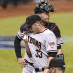 Arizona Diamondbacks' relief pitcher J.B. Bukauskas (33) and catcher Carson Kelly walk to the dugout after the Miami Marlins scored two runs in the seventh inning of a baseball game, Thursday, May 6, 2021, in Miami. (AP Photo/Lynne Sladky)