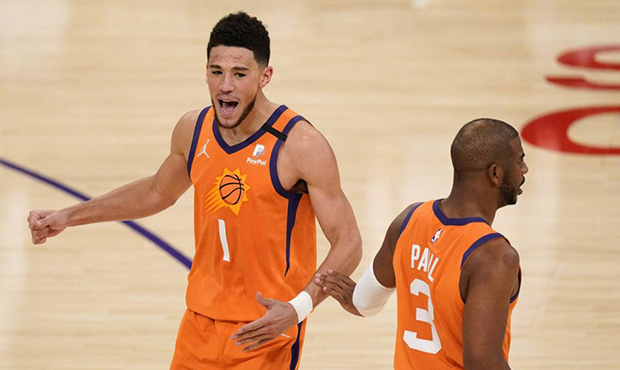 Phoenix Suns guard Devin Booker, left, celebrates with guard Chris Paul during a timeout in the sec...