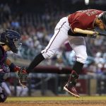 Arizona Diamondbacks' Nick Ahmed, right, jumps out of the way of an inside pitch as Washington Nationals catcher Alex Avila, left, makes the catch during the seventh inning of a baseball game Sunday, May 16, 2021, in Phoenix. (AP Photo/Ross D. Franklin)