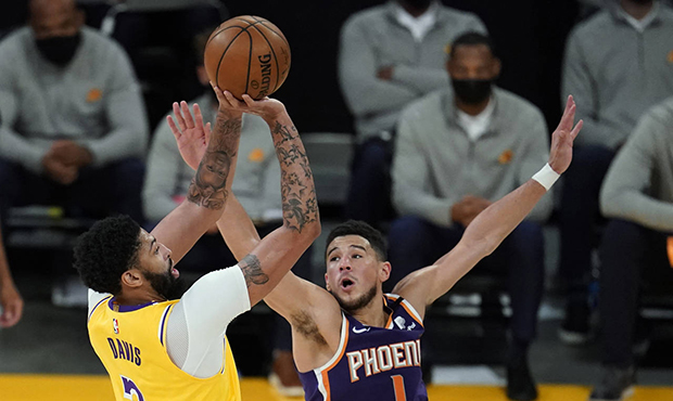 Los Angeles Lakers forward Anthony Davis (3) shoots over Phoenix Suns guard Devin Booker (1) during...