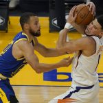 Phoenix Suns guard Devin Booker, right, is defended by Golden State Warriors guard Stephen Curry during the first half of an NBA basketball game in San Francisco, Tuesday, May 11, 2021. (AP Photo/Jeff Chiu)