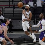 San Antonio Spurs guard Patty Mills (8) passes the ball around Phoenix Suns forward Jae Crowder (99) during the first half of an NBA basketball game in San Antonio, Saturday, May 15, 2021. (AP Photo/Eric Gay)